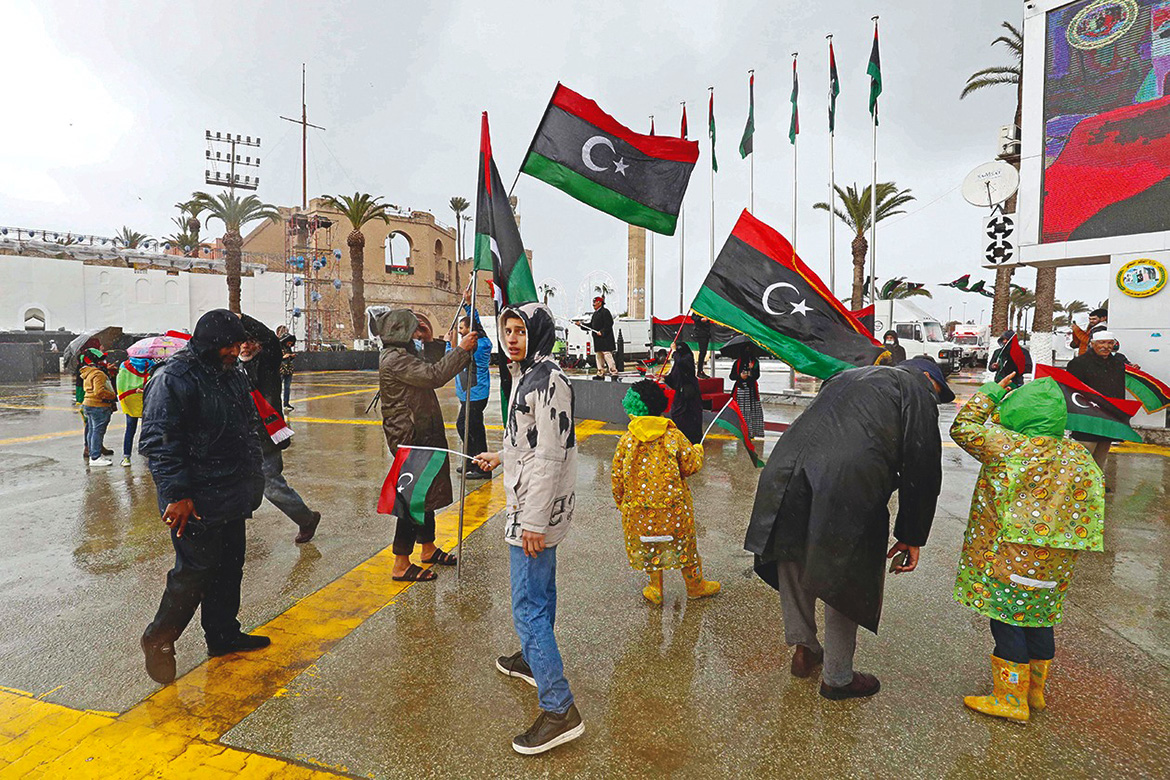 TRIPOLI: Libyans gather in Martyrs' Square yesterday as they commemorate the 11th anniversary of the uprising that toppled longtime strongman Muammar Gaddafi. - AFP
