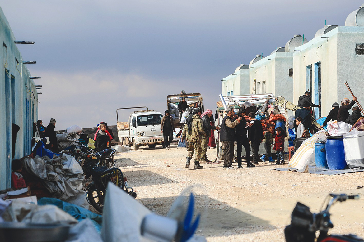 BIZAAH, Syria: Internally displaced Syrians unload their belongings from trucks upon arrival at a new housing complex in the opposition-held area of Bizaah, east of the city of al-Bab in the northern Aleppo governorate, built with the support of Turkey's emergencies agency AFAD. - AFP