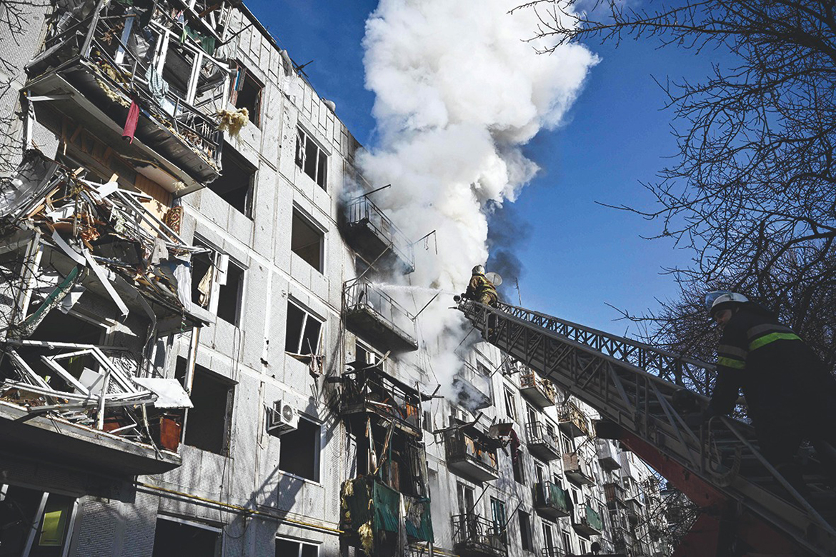 Firefighters work on a fire on a building after bombings on the eastern Ukraine town of Chuguiv yesterday.- AFP photos