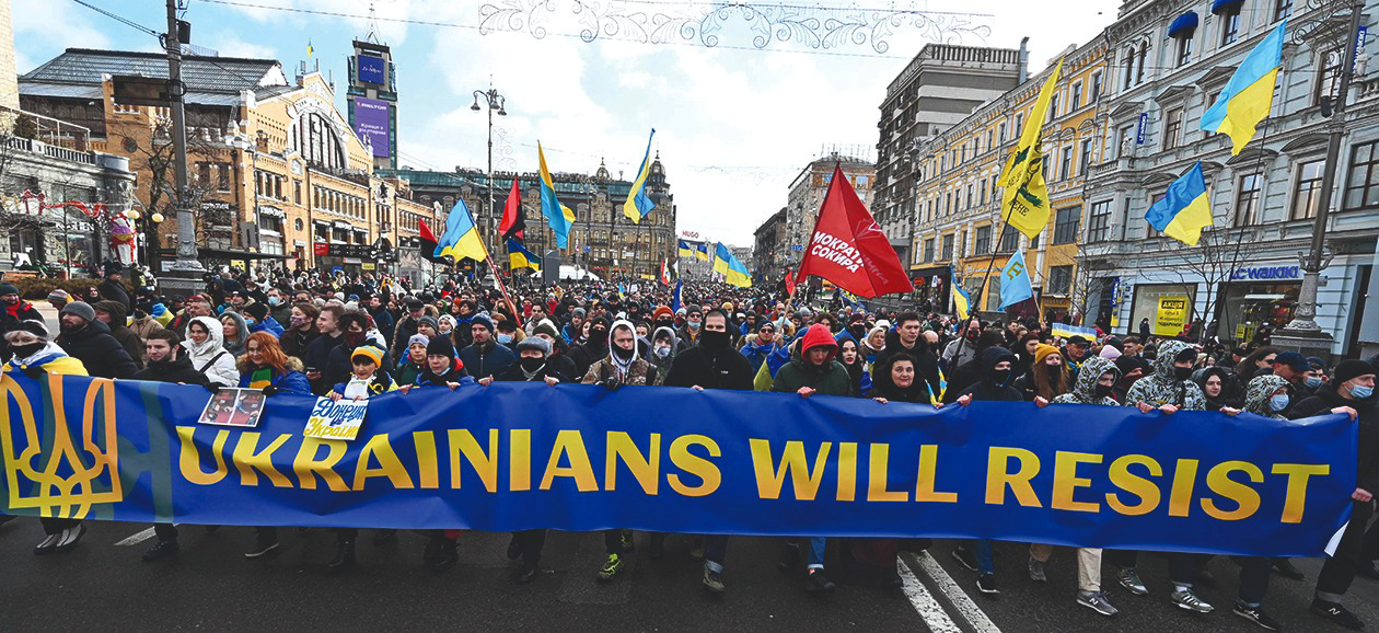 KYIV: Demonstrators shout slogans as they march during a rally yesterday held to show unity amid US warnings of an imminent Russian invasion. – AFP