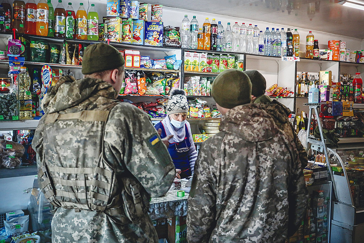AVDIIVKA, Ukraine: Ukraine's Military Forces servicemen shop in the Donetsk region town of Avdiivka, on the eastern Ukraine front-line with Russia-backed separatists yesterday. - AFP