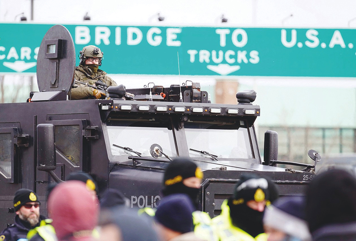 WINDSOR, Canada: Canadian police deploy yesterday to move protesters blocking access to the Ambassador Bridge and demanding an end to government COVID-19 mandates. - AFP