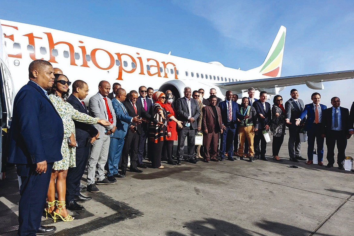 ADDIS ABABA: Ethiopian Airlines employees pose for a group photo in front of a Boing 737 MAX on the tarmac of the Bole International Airport in Addis Ababa yesterday. - AFP
