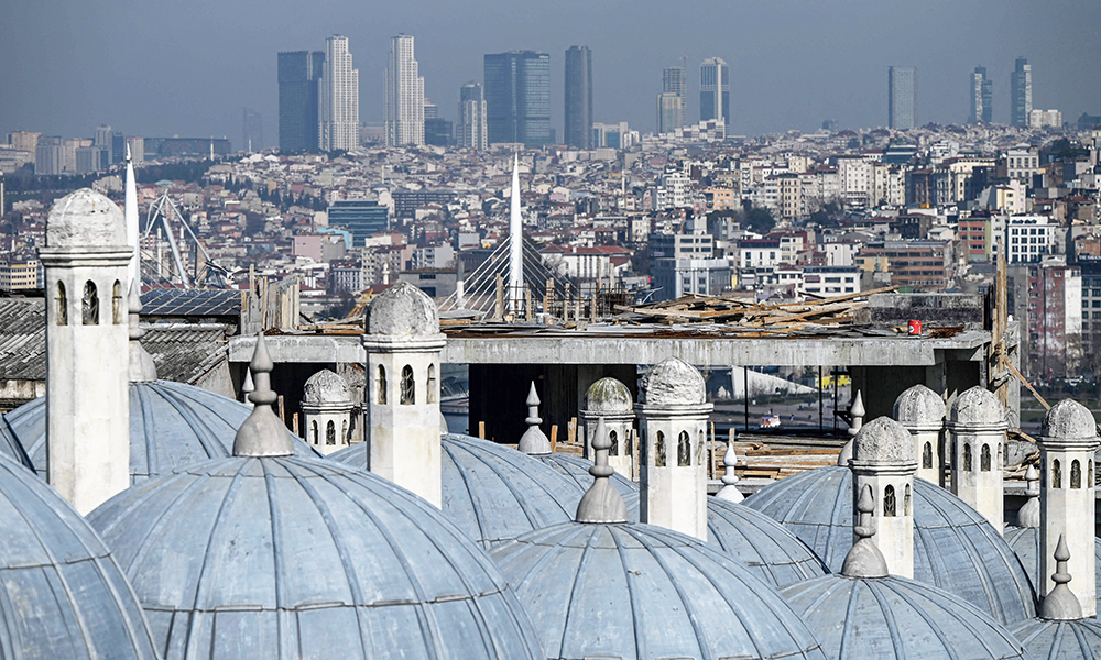 A picture taken on Feb 16, 2022 in Istanbul shows the Suleymaniye Mosque’s domes and a building under construction (back) stopped by the Istanbul metropolitan municipality (IBB). — AFP