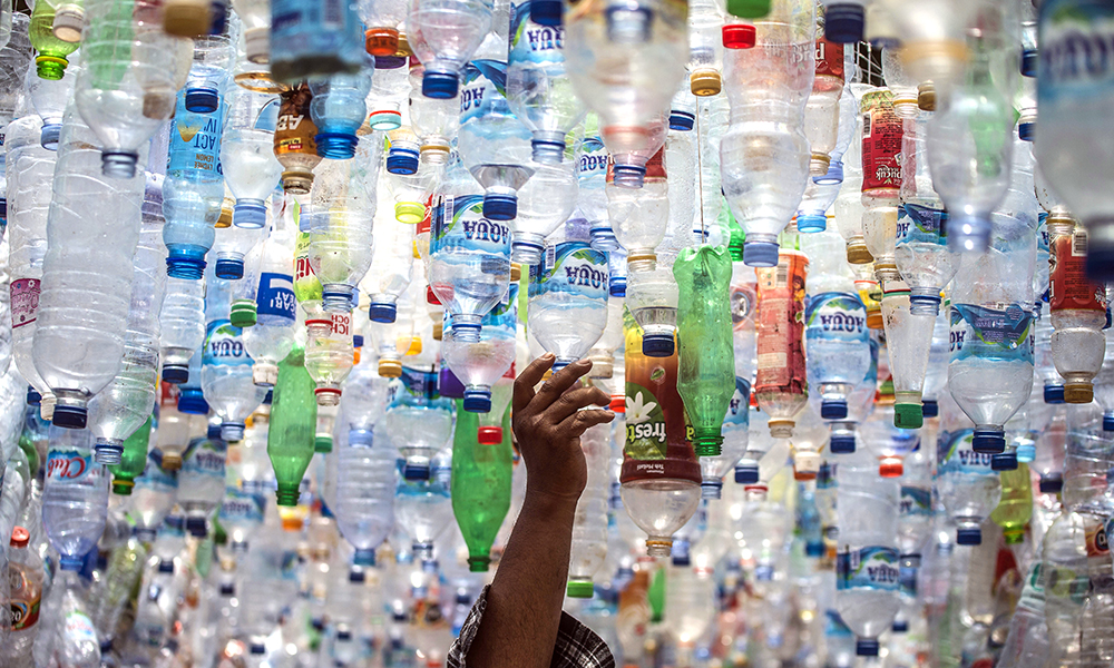 GRESIK, Indonesia:  In this file photo taken on September 17, 2021 an Indonesian activist from ECOTON (ecological observation and wetland conservation) prepares an installation made with used plastic, including 4,444 bottles, collected from the river in Gresik. — AFP