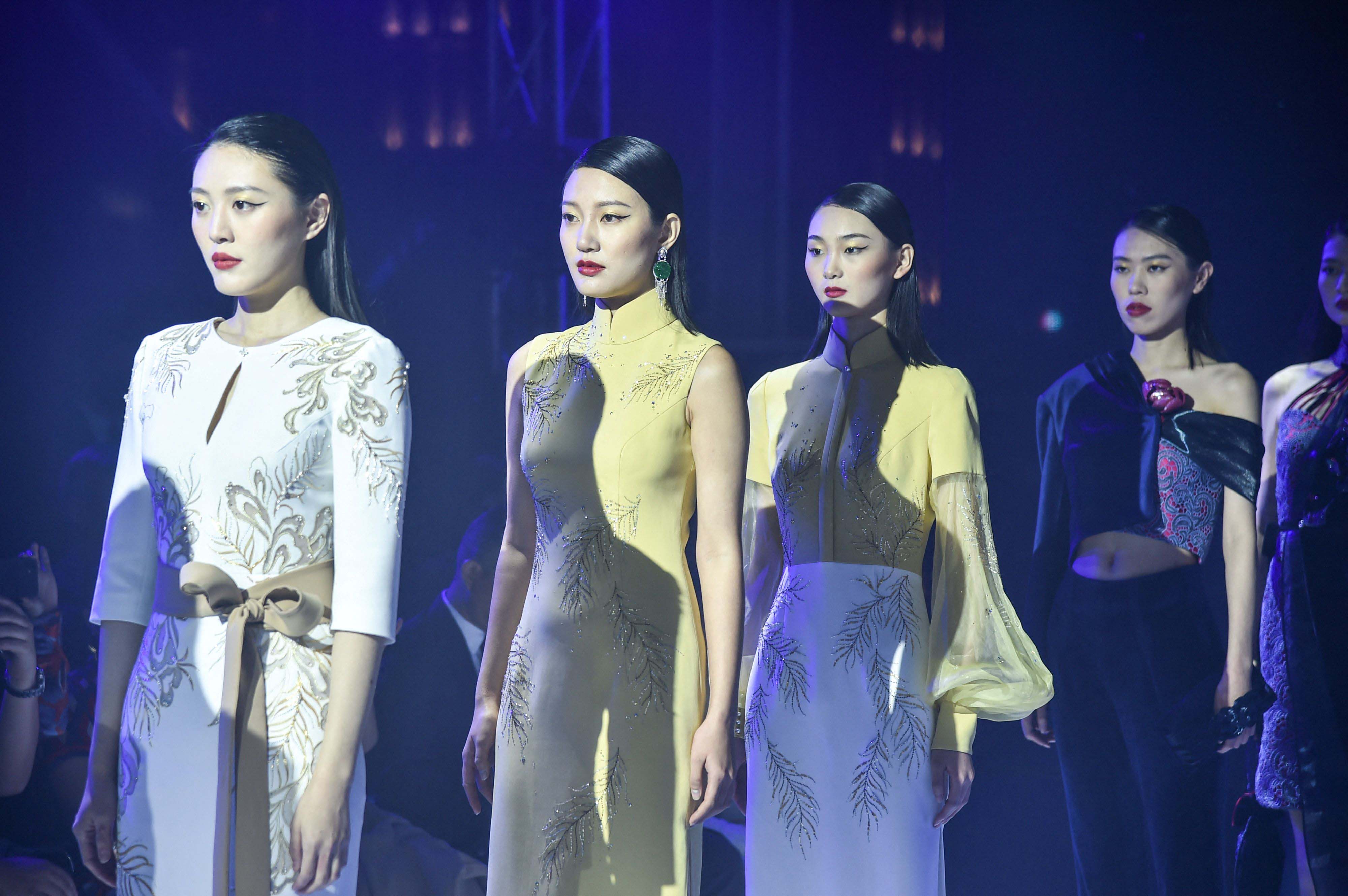 This photo shows models wearing traditional Chinese dress Qipao rehearsing for a Shanghai fashion show.—AFP photosn