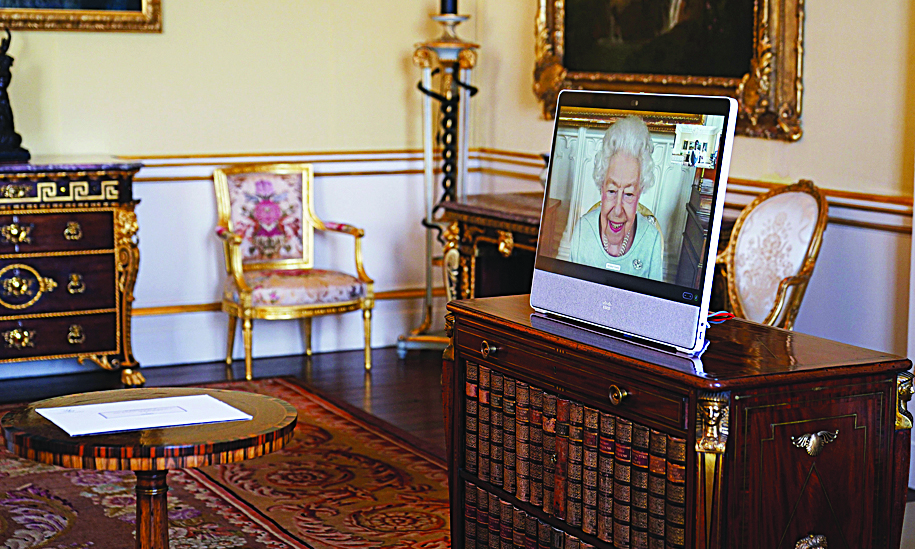 Queen Elizabeth II appears on a screen via videolink from Windsor Castle, where she is in residence.-AFP photosn