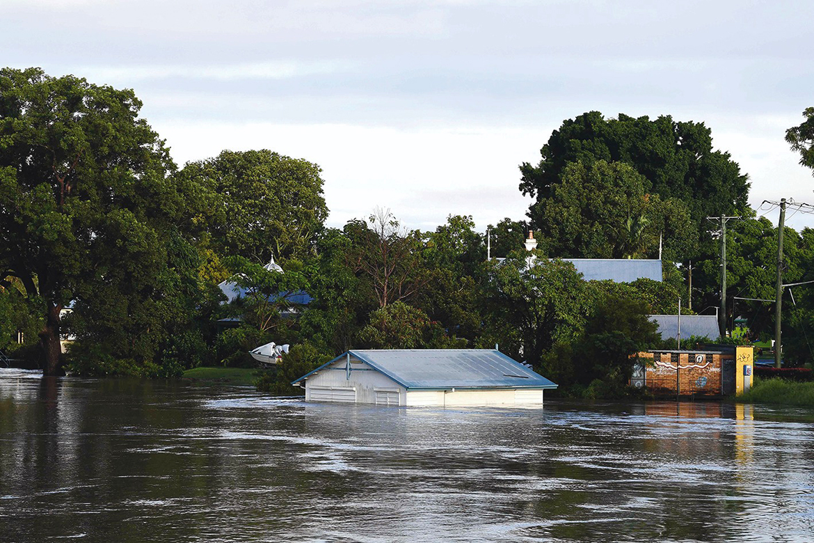 GRAFTON: A submerged shed is seen on the bank of over flowing Clarence River in Grafton, some 130 kms from the New South Wales town Lismore yesterday. - AFP