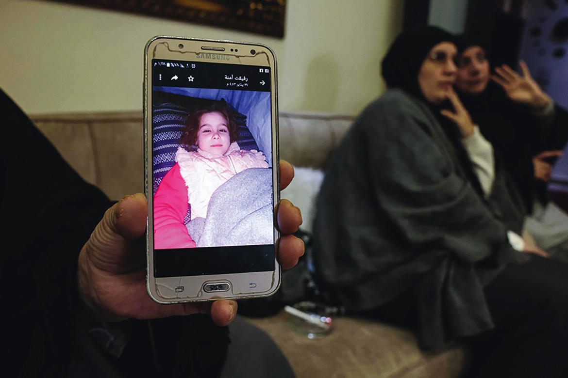TRIPOLI: Noor Al-Huda Abbas, a 59-year-old Lebanese woman whose daughter in law and granddaughter are held at the northeast Syrian camp of Al-Hol, shows a photo of her granddaughter on a phone during an interview.- AFP