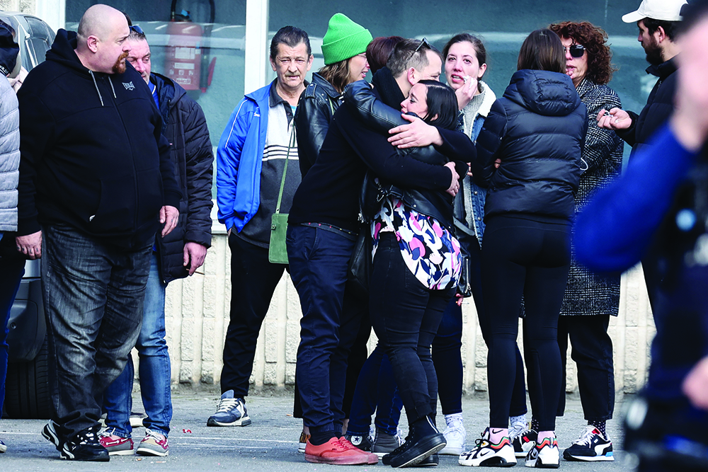 STREPY-BRACQUEGNIES, Belgium: People gather near a gymnasium where witnesses and relatives of victims are received near the site where a car crashed into a crowd of early morning carnival-goers killing six people and injuring 12 people seriously in Strepy-Bracquegnies. - AFPnnn