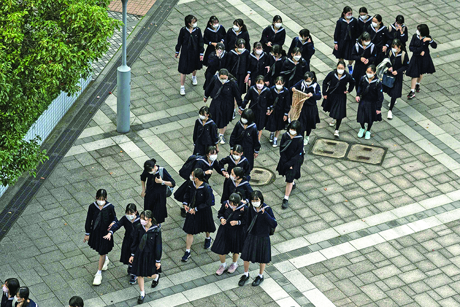 TOKYO: Schoolgirls are pictured after classes in Tokyo.  Every school has its rules, but tough regulations at some Japanese institutions, mandating everything from black hair to white shoelaces, are facing increasing criticism and even legal action. – AFPn
