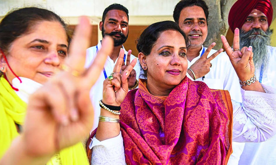 AMRITSAR, India: Aam Aadmi Party (AAP) candidate for Punjab state assembly elections, Jeevanjyot Kaur (C) along with party supporters gestures on the day of counting of the Punjab state assembly election votes in Amritsar yesterday. – AFPnn