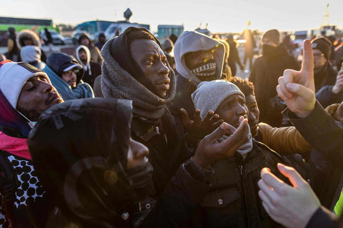 MEDYKA: Refugees from Ukraine gather to take a bus from the border crossing in Medyka to Przemysl, eastern Poland. - AFP