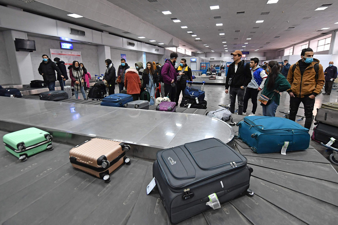 TUNIS: Tunisian students evacuated from Ukraine wait for their luggage bags upon their arrival at the Tunis-Carthage airport on March 1, 2022. - AFP