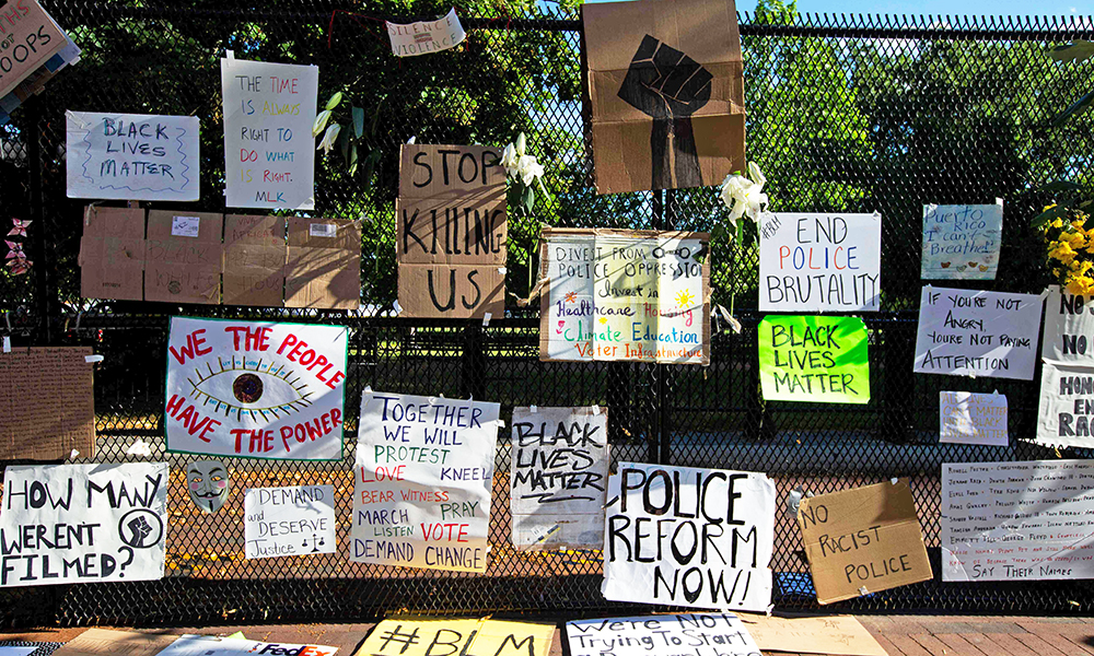 Signs are placed on a fence at Lafayette Square near the White House, during ongoing protests against police brutality and racism, in Washington, DC. —AFP photos
