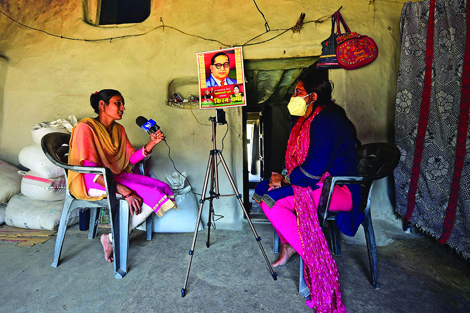 Geeta Devi (right), senior journalist of ‘Khabar Lahariya’ (Waves of News), interviews a woman who she says was abandoned by her husband, while reporting in Banda district, Uttar Pradesh state. – AFP photosn