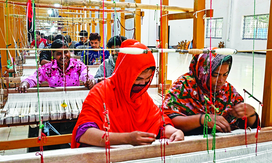 Weavers use handlooms to make traditional muslin garments at the Dhakai Muslin Project facility in Narayanganj. – AFP photosn