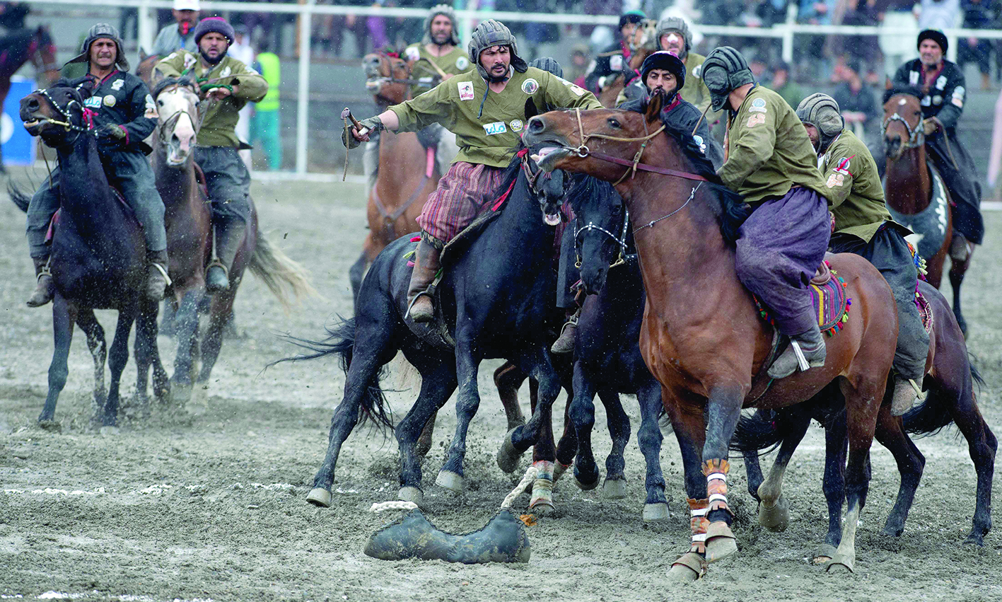 KABUL: Horsemen from Kandahar team (in black) and Kunduz team compete during the final of Afghanistan's Buzkashi League on March 6, 2022. - AFP n