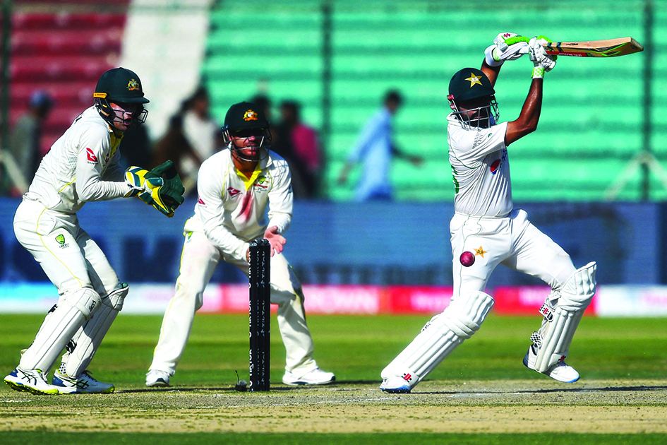 KARACHI: Pakistan’s captain Babar Azam (right) plays a shot during the fifth and final day of the second Test cricket match between Pakistan and Australia yesterday.- AFPn