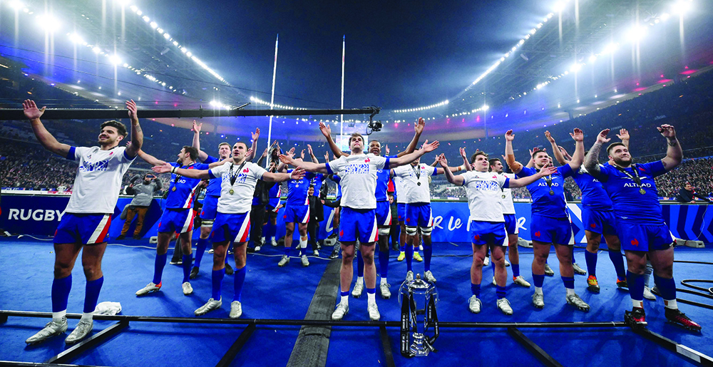 SAINT-DENIS: France's players celebrate after winning the Six Nations rugby union tournament following a win in the match between France and England on March 19, 2022. - AFPn