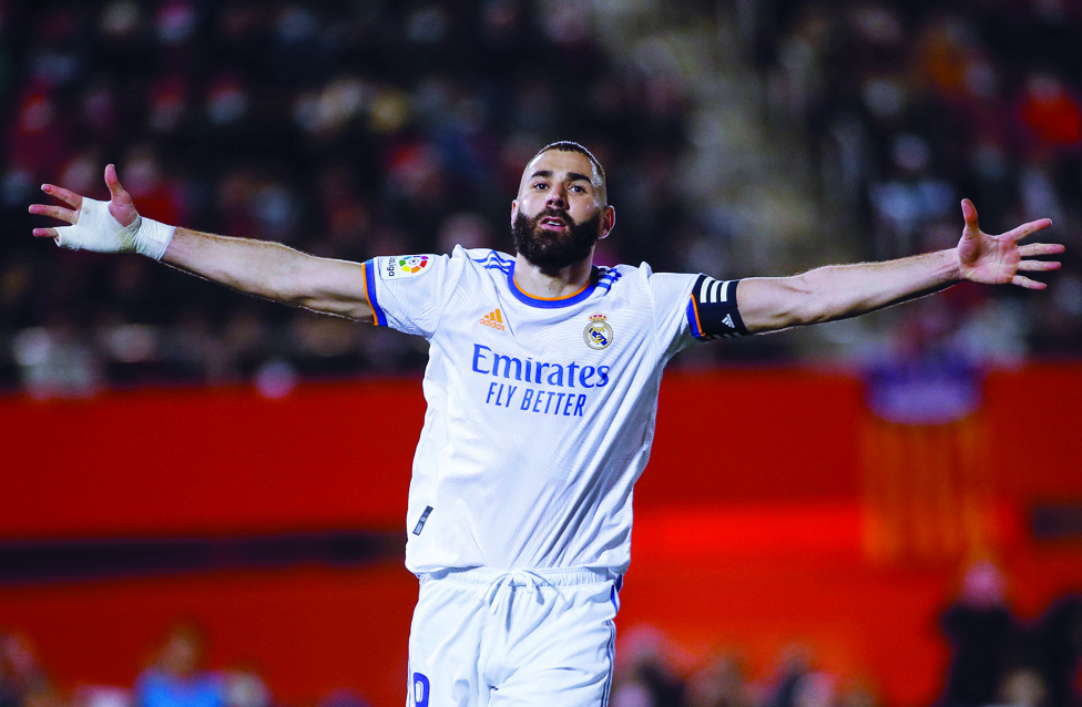 PALMA: Real Madrid's French forward Karim Benzema celebrates after scoring his team's second goal during the Spanish League football match between RCD Mallorca and Real Madrid CF on March 14, 2022. - AFPn