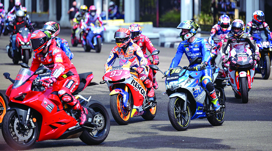 JAKARTA: Repsol Honda Team's Spanish rider Marc Marquez (center, #93) and other MotoGP riders take part in a motorcycle parade in downtown Jakarta yesterday.- AFPn