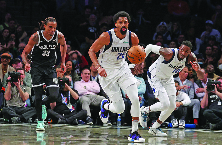 NEW YORK: Spencer Dinwiddie #26 of the Dallas Mavericks drives against Nic Claxton #33 of the Brooklyn Nets during their game at Barclays Center on March 16, 2022.- AFPn