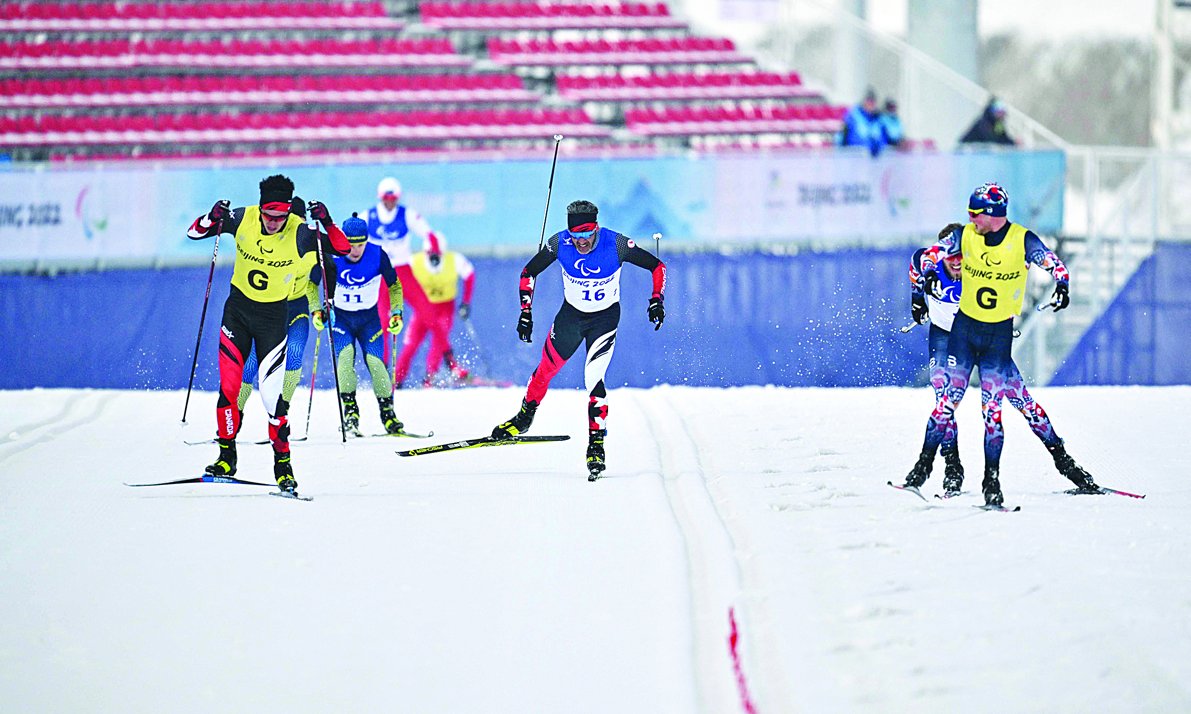 ZHANGJIAKOU: Canada's Brian McKeever (center) races towards the finish line during the men's middle distance free technique vision impaired para cross-country skiing event yesterday at the Zhangjiakou National Biathlon Centre.- AFPn