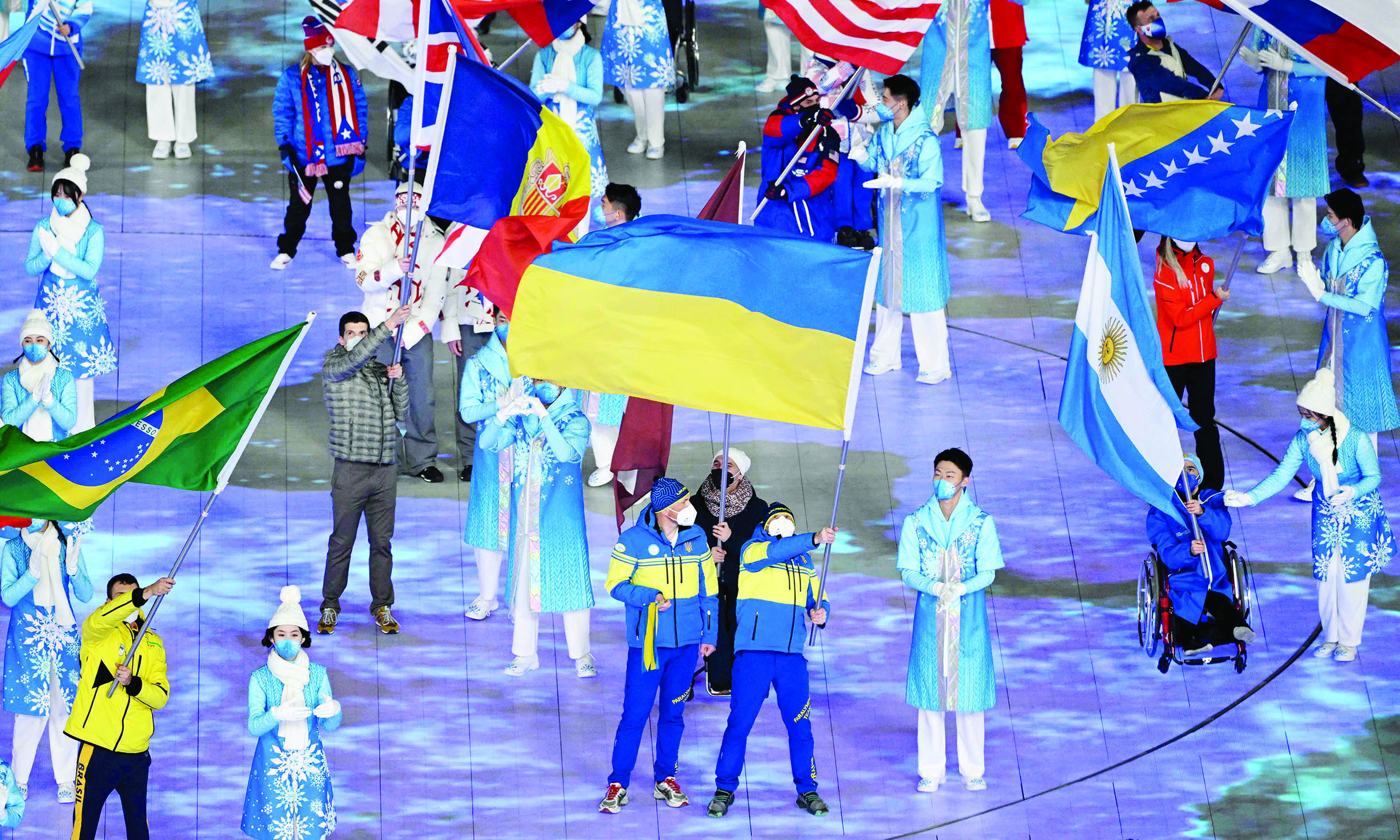 BEIJING: Flagbearer Ukraine's Vitalii Lukianenko (right) takes part in the closing ceremony of the Beijing 2022 Winter Paralympic Games at the National Stadium, known as the Bird's Nest in Beijing yesterday.- AFPnnn