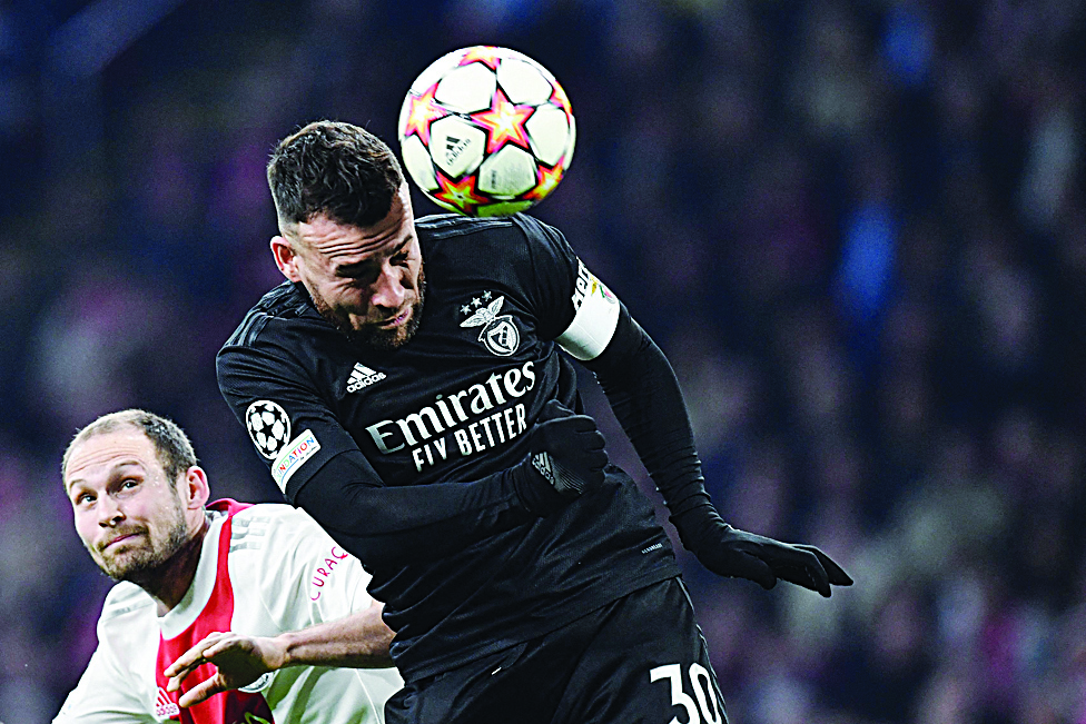 AMSTERDAM: Benfica's Argentine defender Nicolas Otamendi (right) and Ajax Amsterdam's Dutch midfielder Daley Blind go for a header during the UEFA Champions League round of 16 second leg football match on March 15, 2022. - AFPn