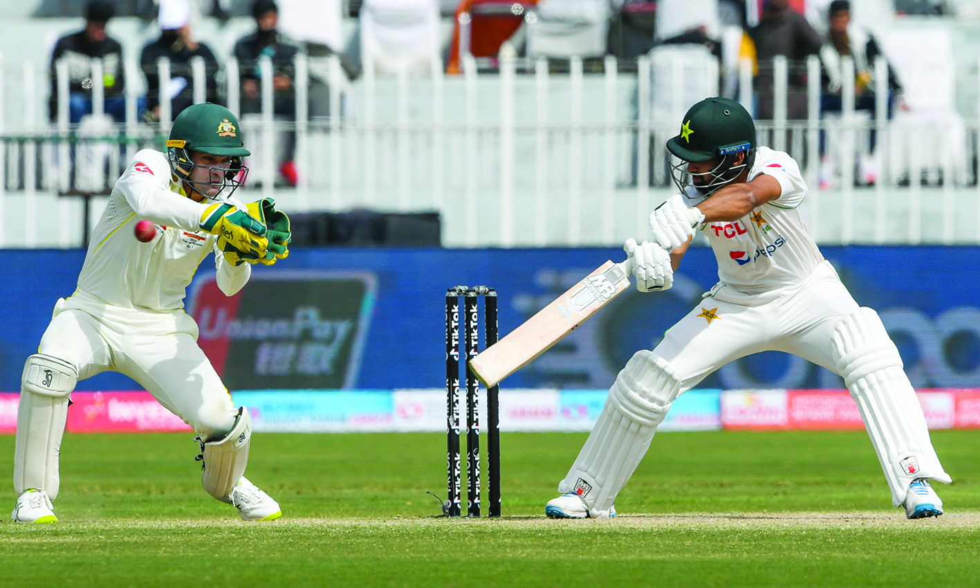 RAWALPINDI: Pakistan's Abdullah Shafique (right) plays a shot during the fifth day of the first Test cricket match between Pakistan and Australia at the Rawalpindi Cricket Stadium yesterday.- AFPn