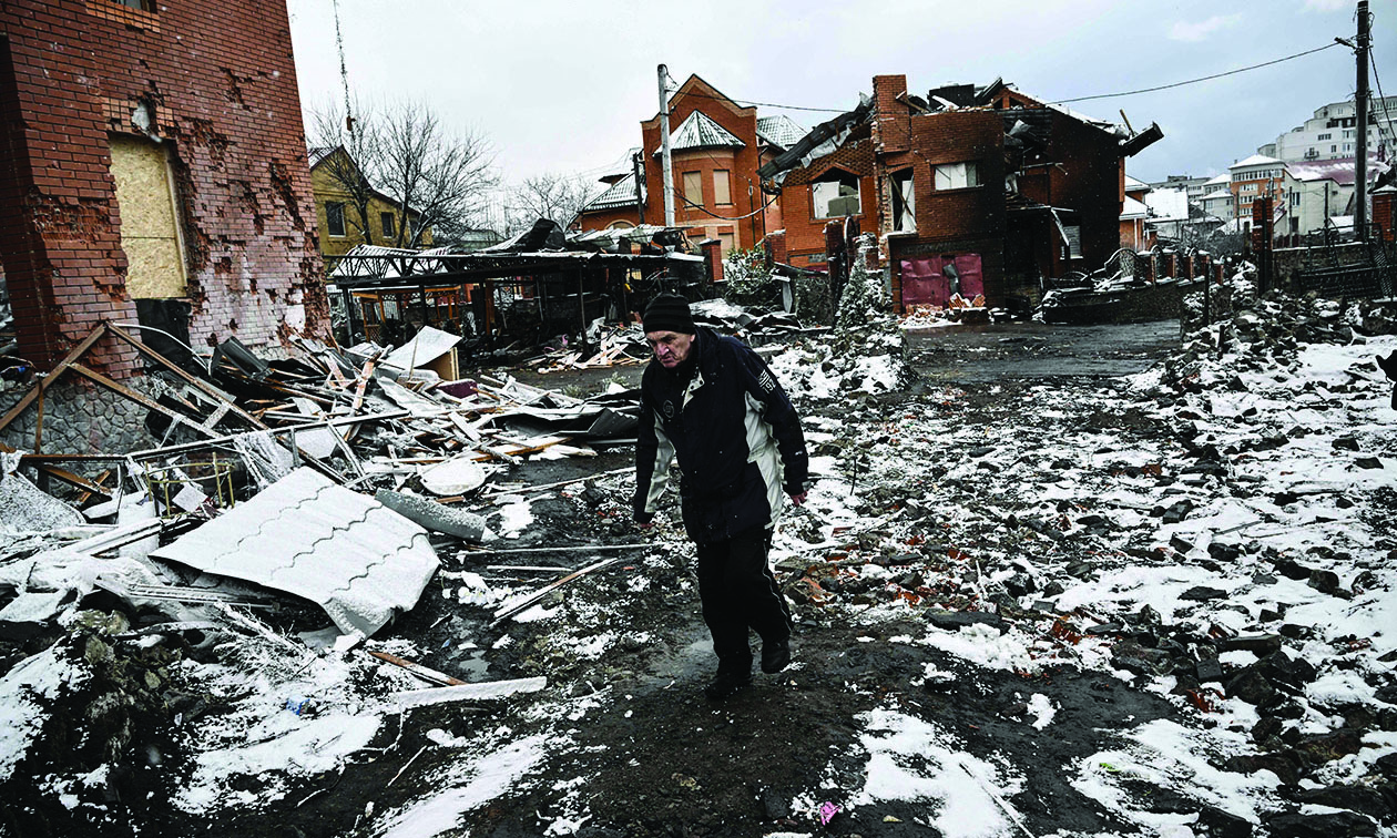 BILA TSERKVA, Ukraine: A man walks between houses destroyed during air strikes on this central Ukrainian city yesterday. - AFP n