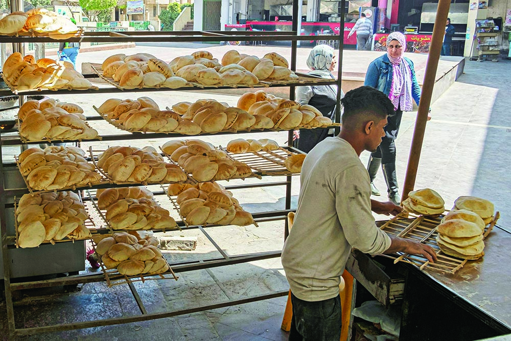 CAIRO: An Egyptian man works in a bakery at a market yesterday. - AFPn