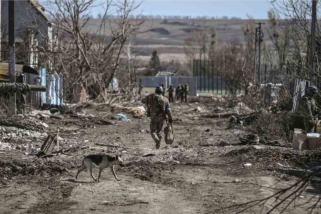 MALA ROGAN, Ukraine: A Ukrainian serviceman walks in this village east of Kharkiv after Ukrainian troops retook it on March 28, 2022. - AFP