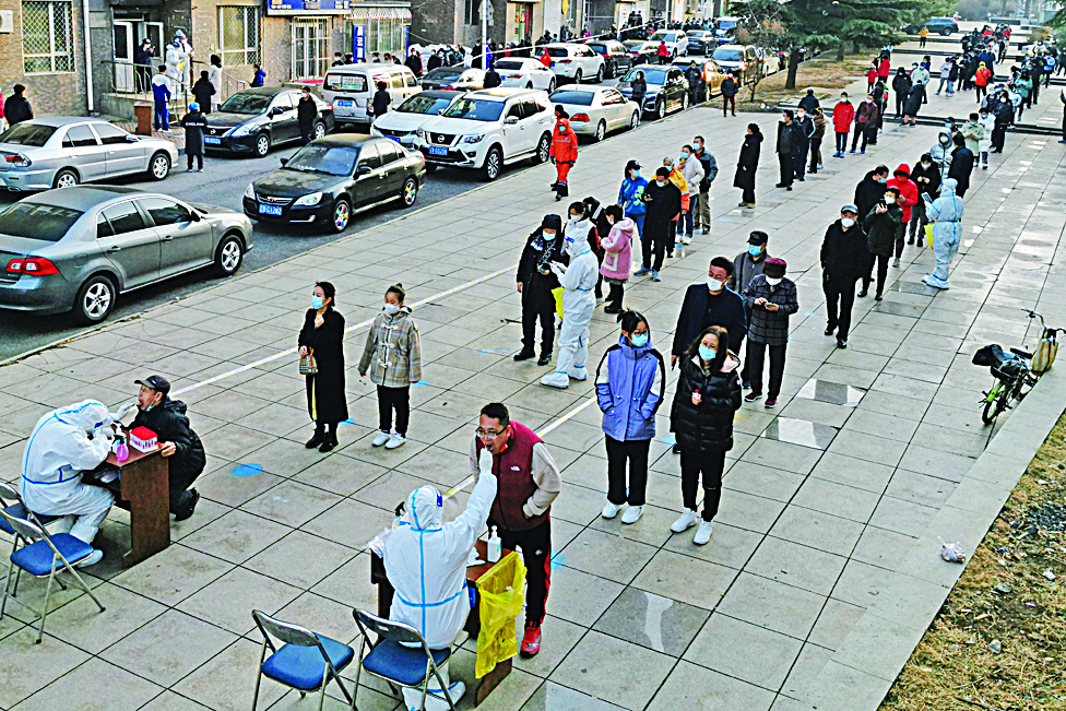 DALIAN, China: Residents queue to undergo nucleic acid tests for the COVID-19 coronavirus in Dalian, in China's northeastern Liaoning province yesterday.-AFPn