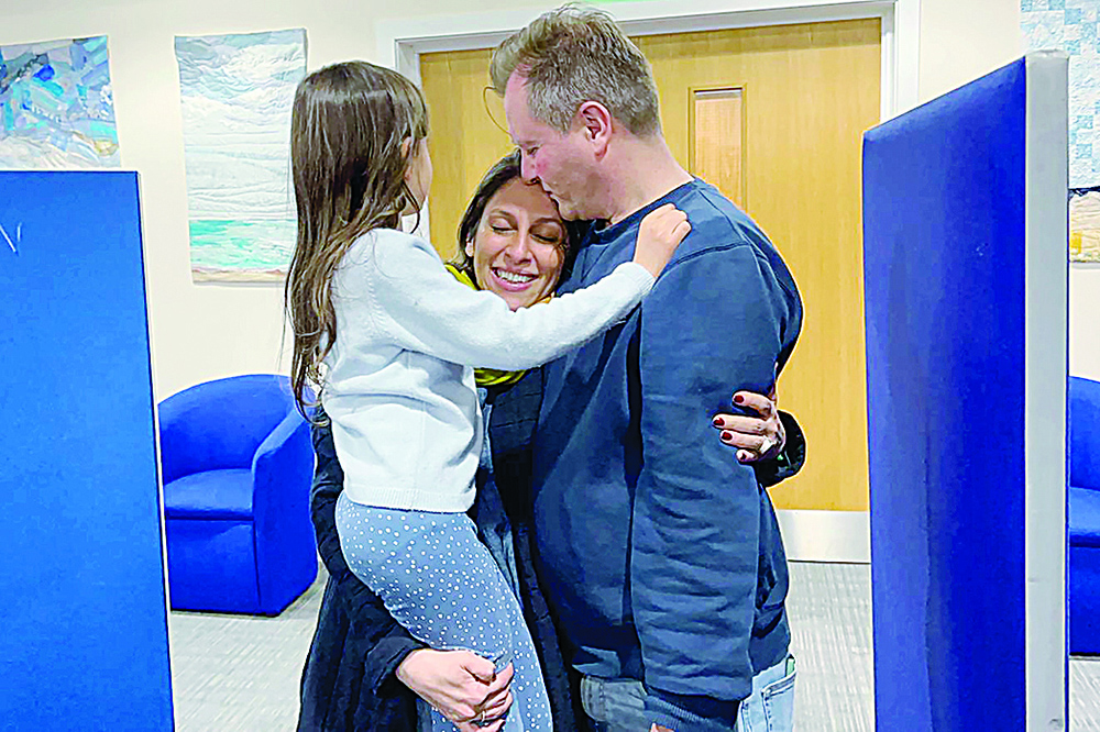 BRIZE NORTON, UK: A handout picture released by the Free Nazanin campaign group shows Nazanin Zaghari-Ratcliffe (center) hugging her husband Richard Ratcliffe (right) and their daughter Gabriella upon her arrival at RAF Brize Norton.-AFPnn