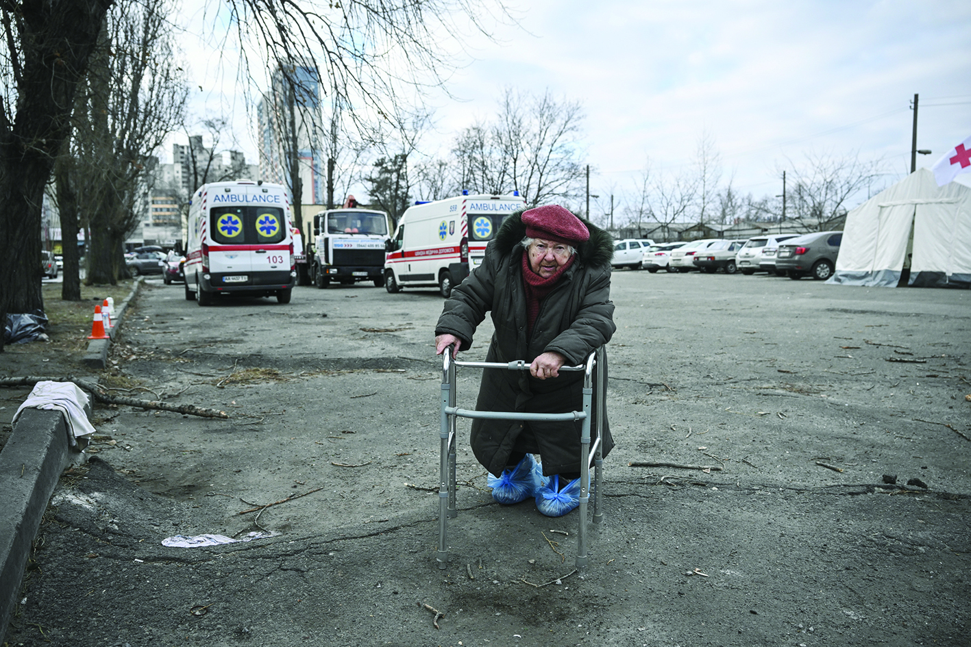 KYIV: An elderly woman leans on her walker as she stands outside a destroyed apartment building following shelling in the northwestern Obolon district of Kyiv yesterday. - AFPn