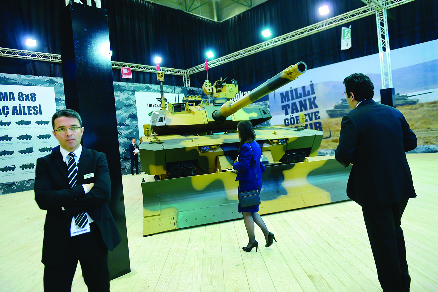 ISTANBUL: This file photo shows a woman looking at an armed military vehicle during the opening day of the 13th International Defense Industry Fair (IDEF) in Istanbul. - AFPn