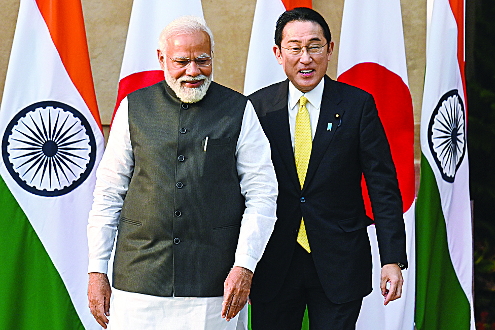 NEW DELHI: Japan's Prime Minister Fumio Kishida (right) and his Indian counterpart Narendra Modi arrive for a photo opportunity before their meeting at the lawns of the Hyderabad House in New Delhi yesterday. - AFPn