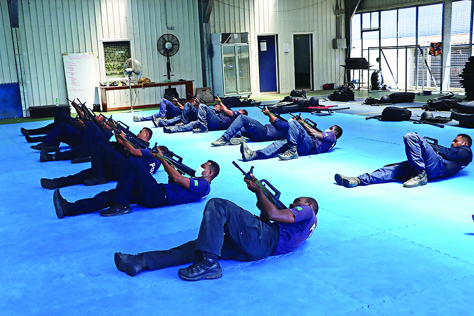 HONIARA, Solomon Islands: An undated handout photo released on March 29, 2022 by the Royal Solomon Islands Police Force (RSIPF) shows China Police Liason Team officers training local RSIPF officers in drill, unarmed combat skills, advanced usage of long sticks, round shields, tactical batons, T-shape baton, handcuffs, basic rifle tactics and crowd control. – AFP