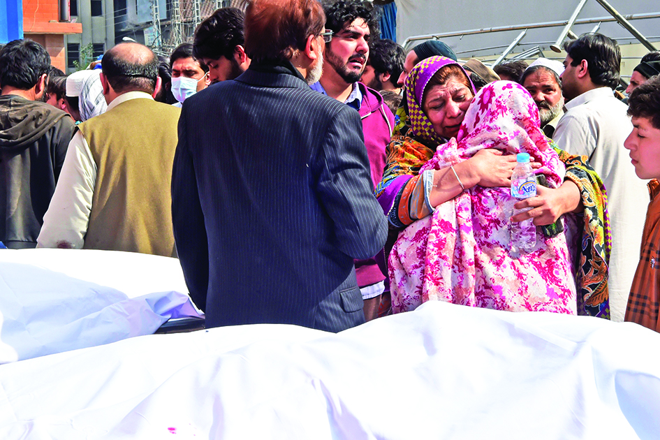 PESHAWAR, Pakistan: Relatives mourn the death of their relatives outside a hospital following a bomb blast at a mosque in Peshawar. – AFPnn