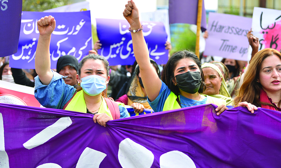 ISLAMABAD: Aurat March protesters hold placards and shout slogans as they gather to mark the International Women's Day in Islamabad yesterday. – AFPn