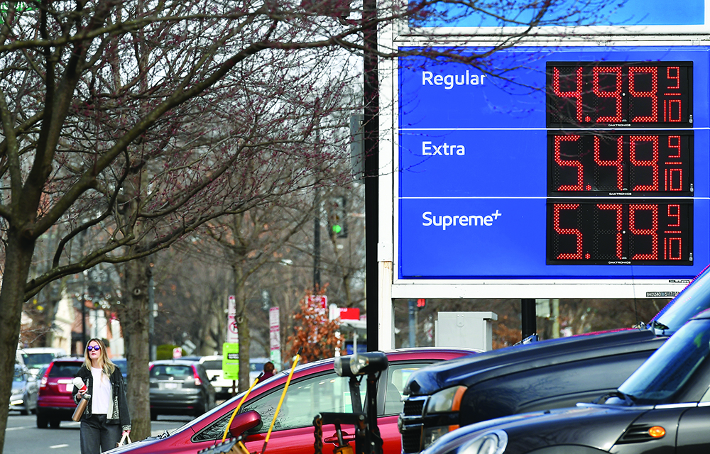 A sign shows gas prices outside a gas station in Washington DC.  - AFP