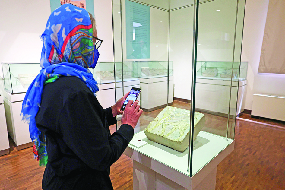 A visitor attends an exhibition entitled the Repatriated Boukan Glazed Brick Collection from Switzerland, at Iran's National Museum in Tehran.—AFP photos