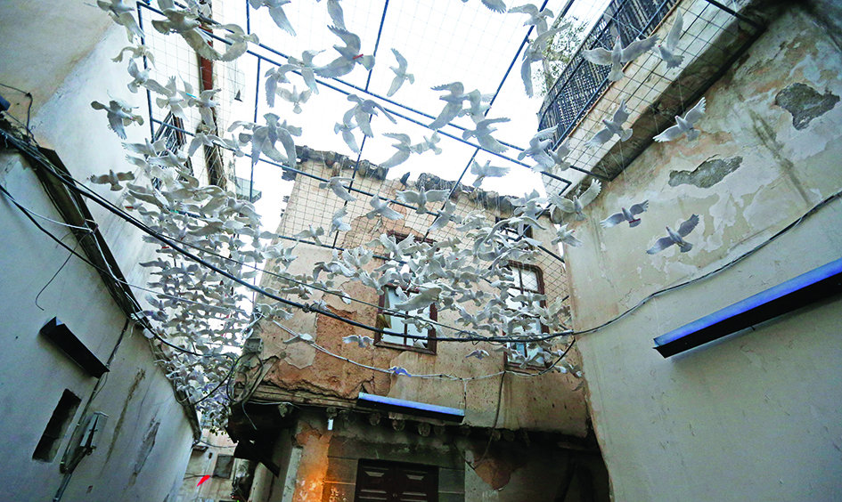 Photos show art installations using ceramic doves is pictured in an alley in old Damascus, as part of an exhibition titled 'Once Upon a Time… Windows', in the Syrian capital.—AFP photos
