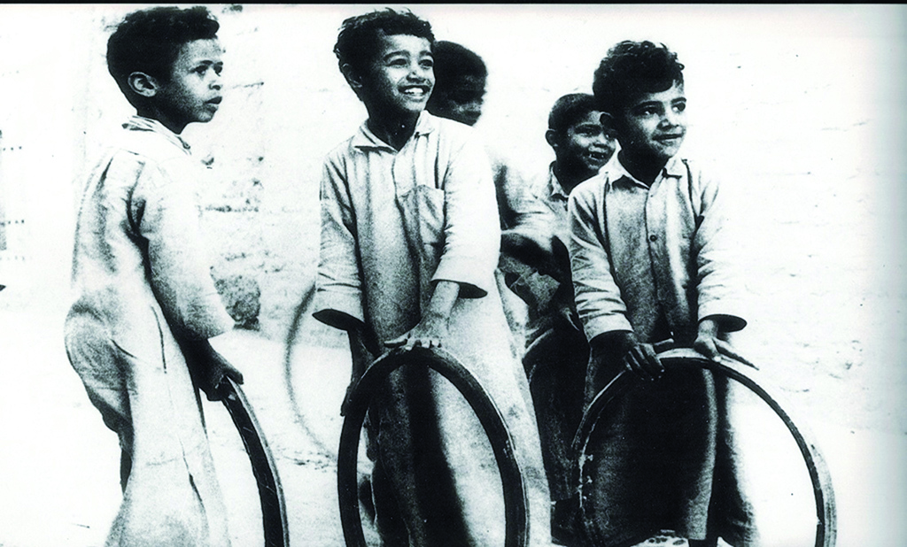 KUWAIT: Al-Derbaha, a famous children's game from the Kuwaiti heritage. The boys race while moving the frame forward, and whoever finishes first is the winner. The picture was taken circa 1958 in Mirqab and shows Ali Salimi (left), brothers Shuaibi (at the back) and brothers Faheed. (Source: A total commemorative printed images to the Ministry of Information in the 19602 and 1970s. Prepared by Mahmoud Zakaria Abu Alella, heritage researcher at the Ministry of Information)