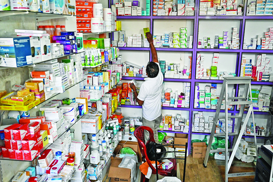 COLOMBO: In this picture taken on April 21, 2022, a pharmacist arranges medicine boxes at a local drug store in Colombo. Sri Lanka used to import around 85 percent of its pharmaceutical supplies but is suffering its worst economic crisis since 1948. – AFP