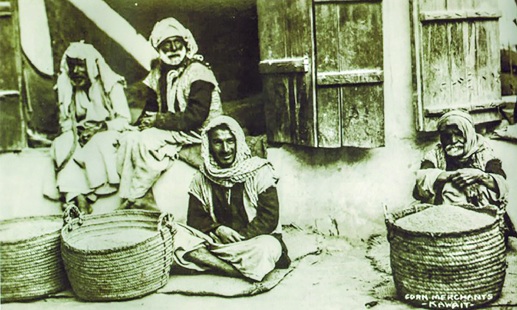 KUWAIT: This postcard image of 1928 from the collection of the British Army shows a group of dry grain vendors offering their goods like rice and chickpeas to potential buyers in front of some shops.  The photo by Mohdzakaria Abu El Ella, a researcher in the Heritage, Ministry of Information.