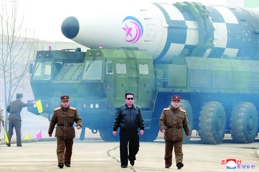 File picture shows North Korean leader Kim Jong Un (C) walking near what a state media report says was a new type inter-continental ballistic missile (ICBM) before its test launch at an undisclosed location in North Korea. - AFP