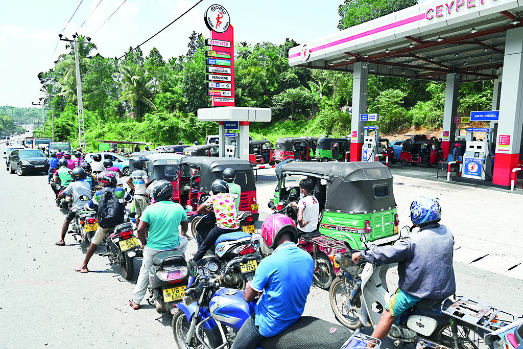 COLOMBO: Motorists queue to fill their tanks up at a Ceylon Petroleum Corporation fuel station in Colombo on April 12, 2022. - AFP